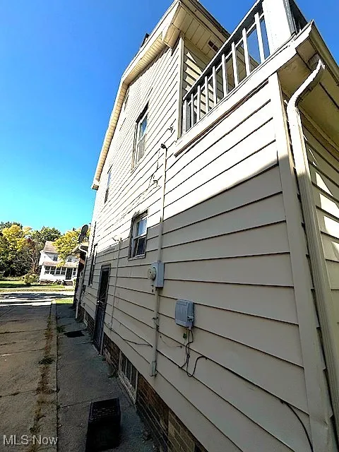 View of side of property featuring a balcony