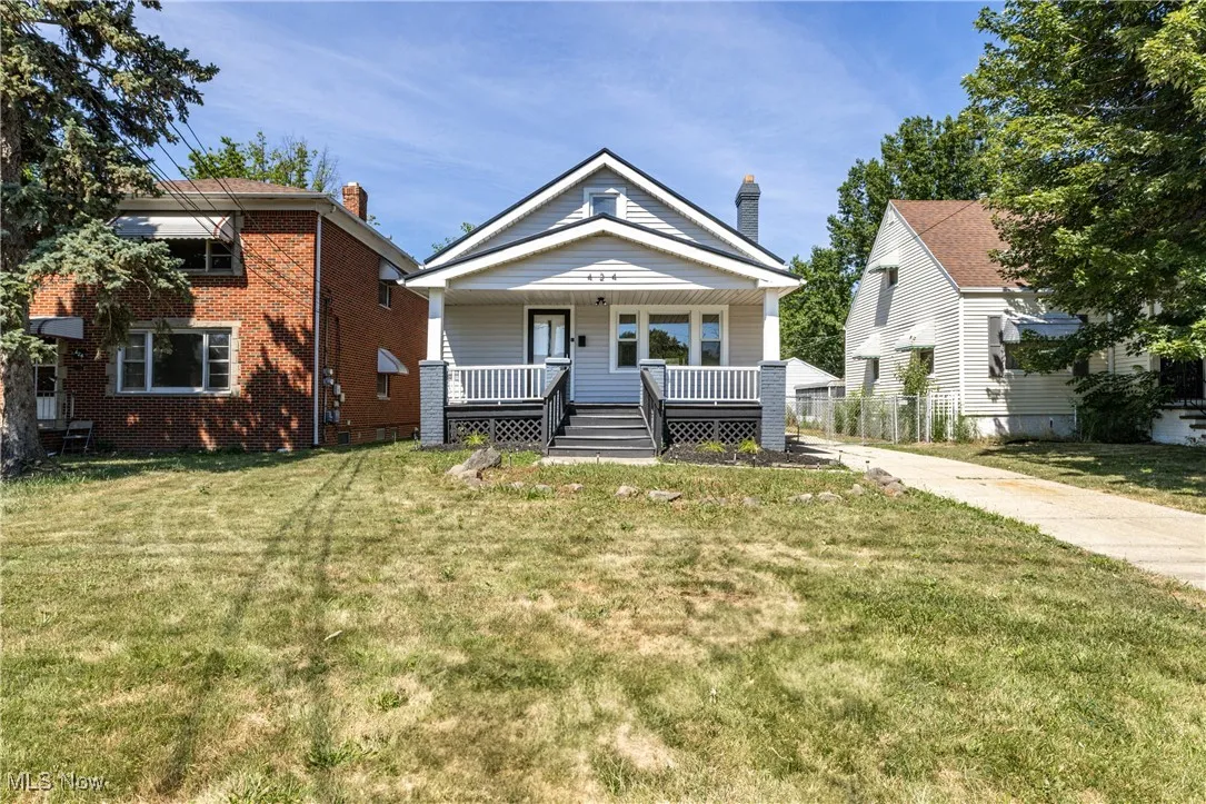 View of front of house with a porch and a front yard