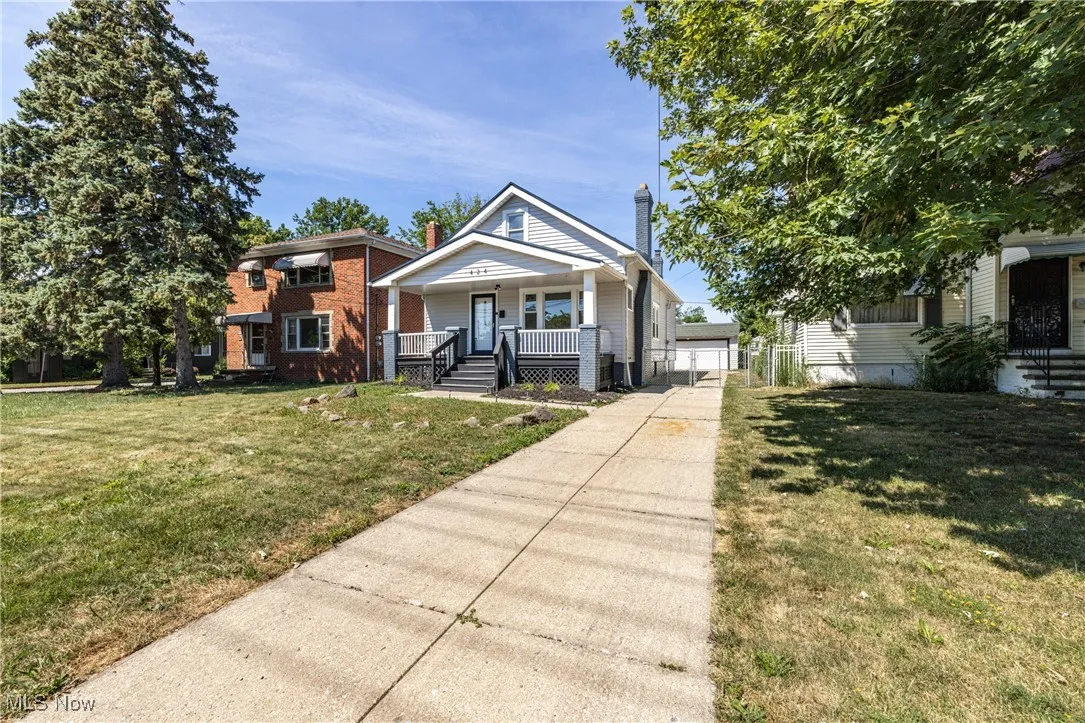 View of front of property featuring covered porch and a front lawn