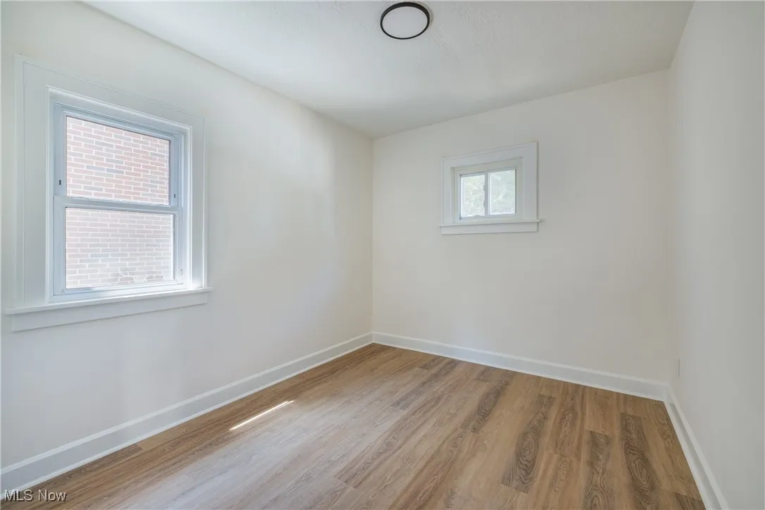 Unfurnished room with baseboards and wood finished floors
