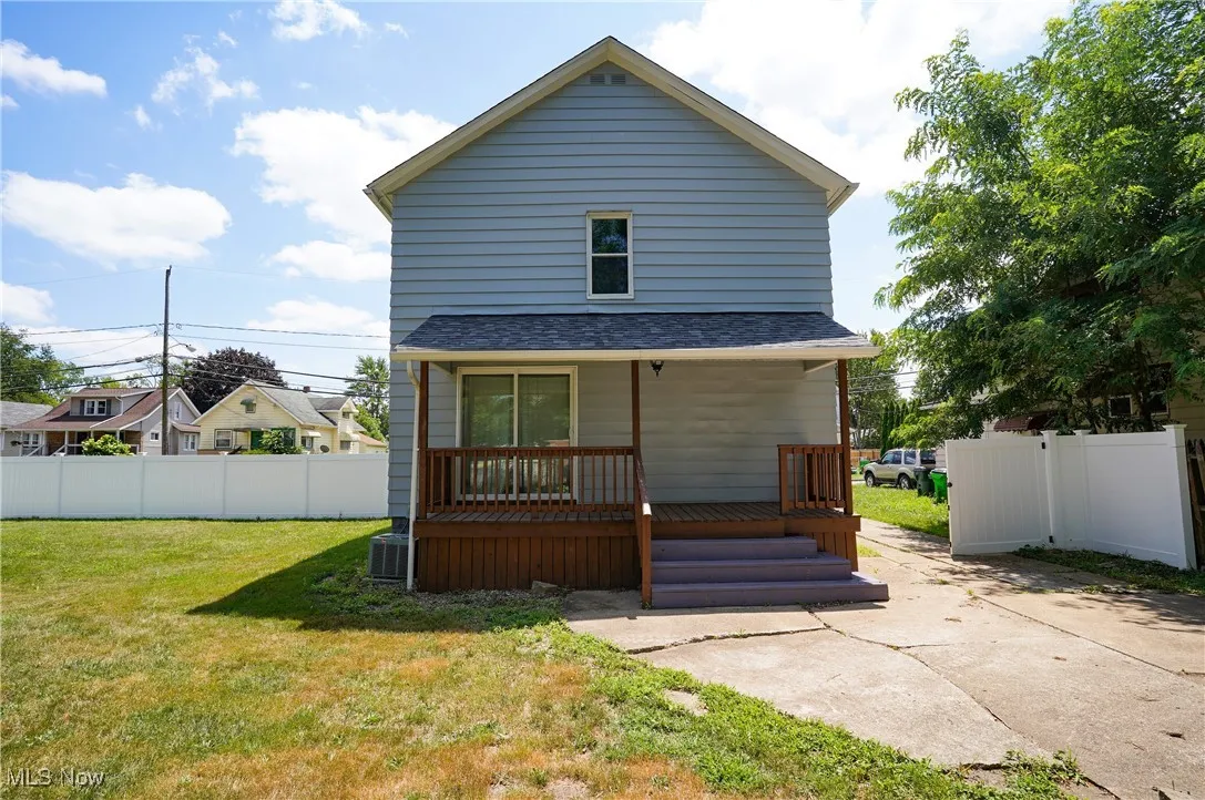 Back of house featuring a shingled roof
