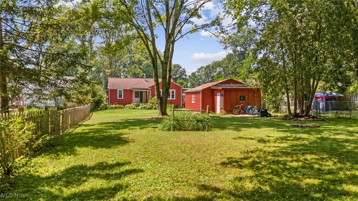Fenced backyard with an outbuilding
