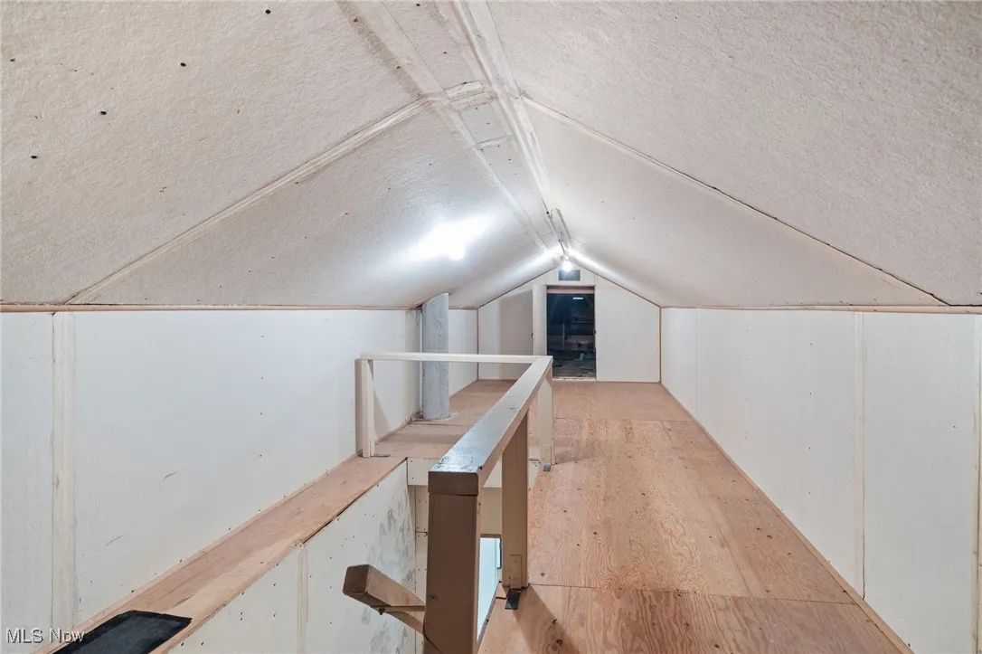 Additional living space with lofted ceiling and a textured ceiling