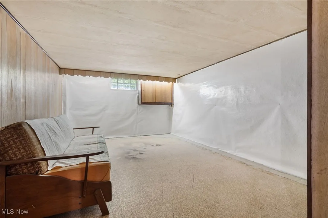 Unfurnished room with carpet flooring and wood walls
