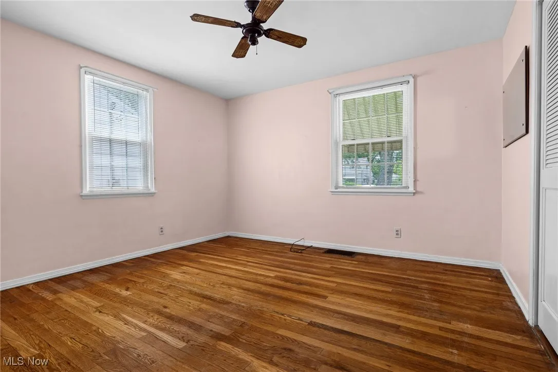 Spare room with a ceiling fan and wood finished floors