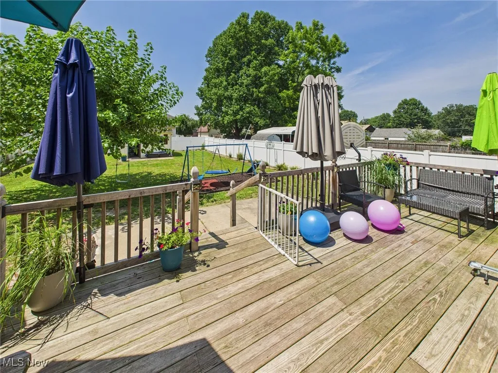 Wooden deck off kitchen overlooking back yard