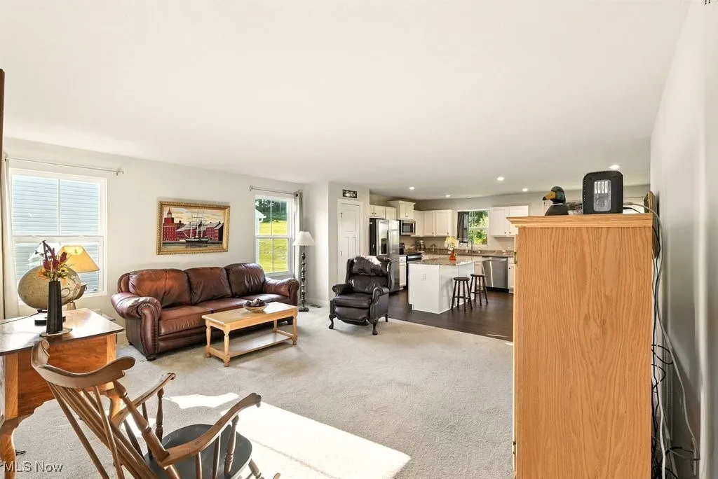 Living room with plenty of natural light, recessed lighting, and carpet floors