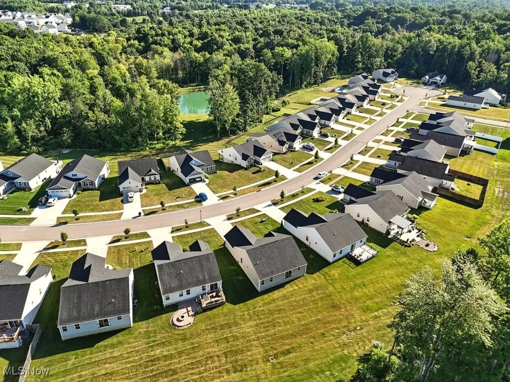 Aerial overview of property's location featuring a heavily wooded area and nearby suburban area