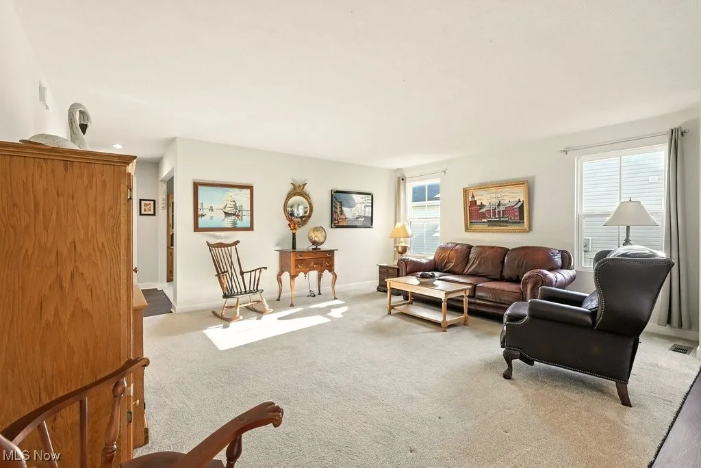 Living room featuring baseboards and carpet