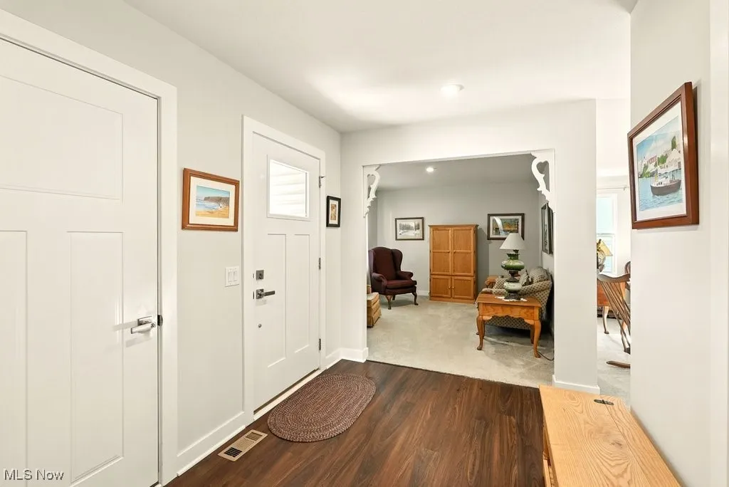 Entryway featuring dark wood-style floors and recessed lighting