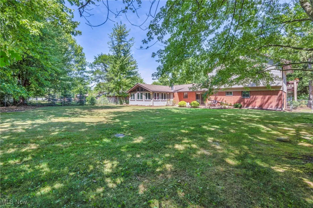 Fenced backyard with a sunroom