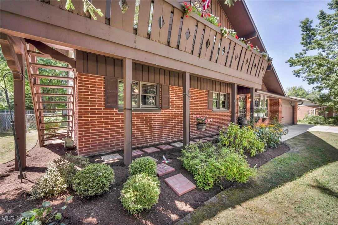 View of side of home featuring brick siding, board and batten siding, concrete driveway, and an attached garage