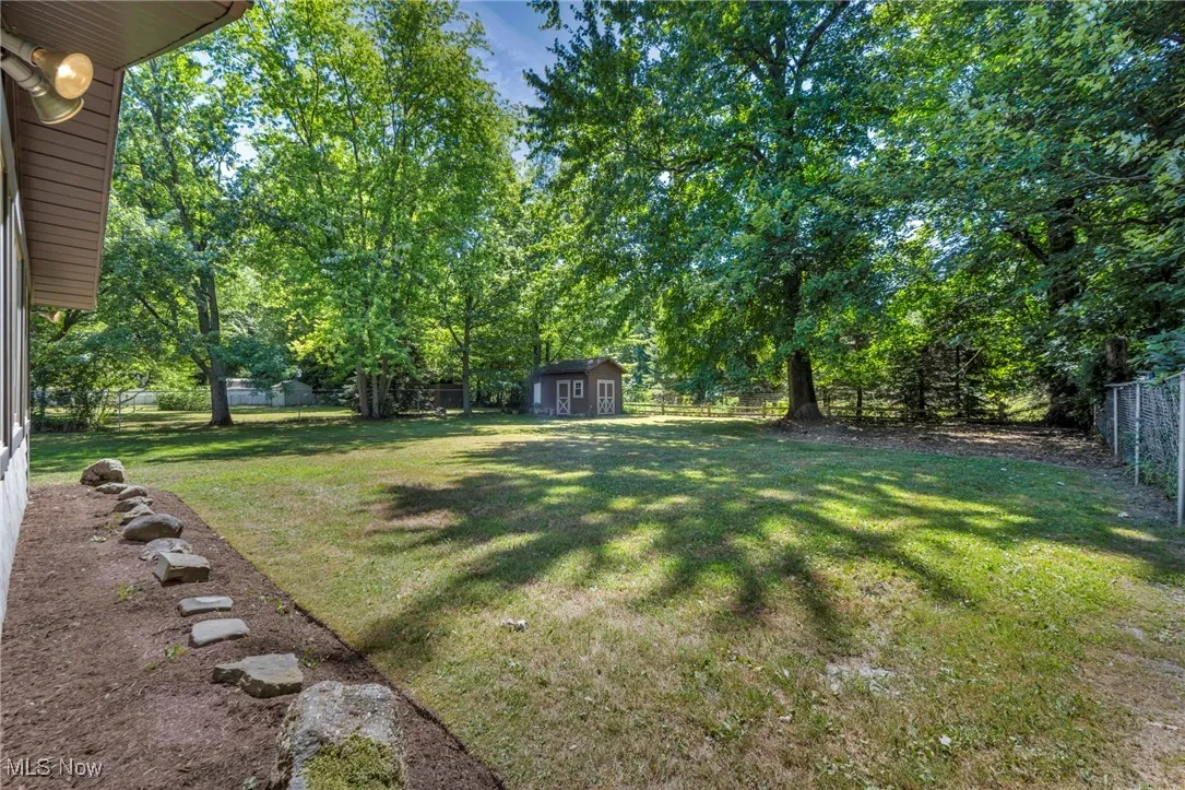 Fenced backyard with a shed