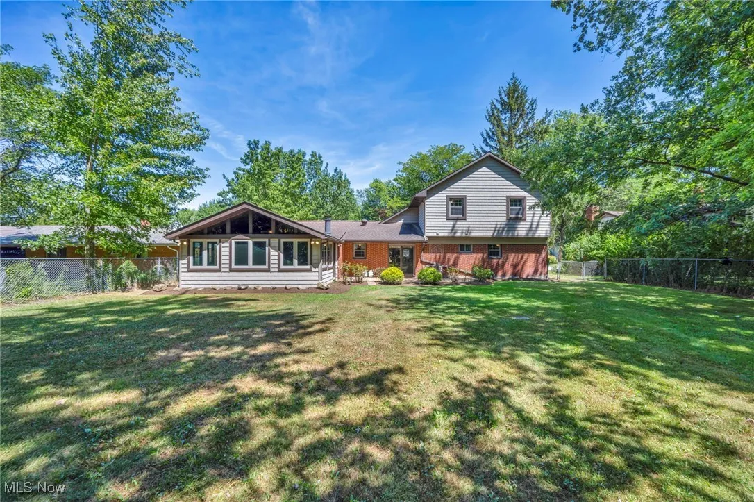 Rear view of property featuring a fenced backyard