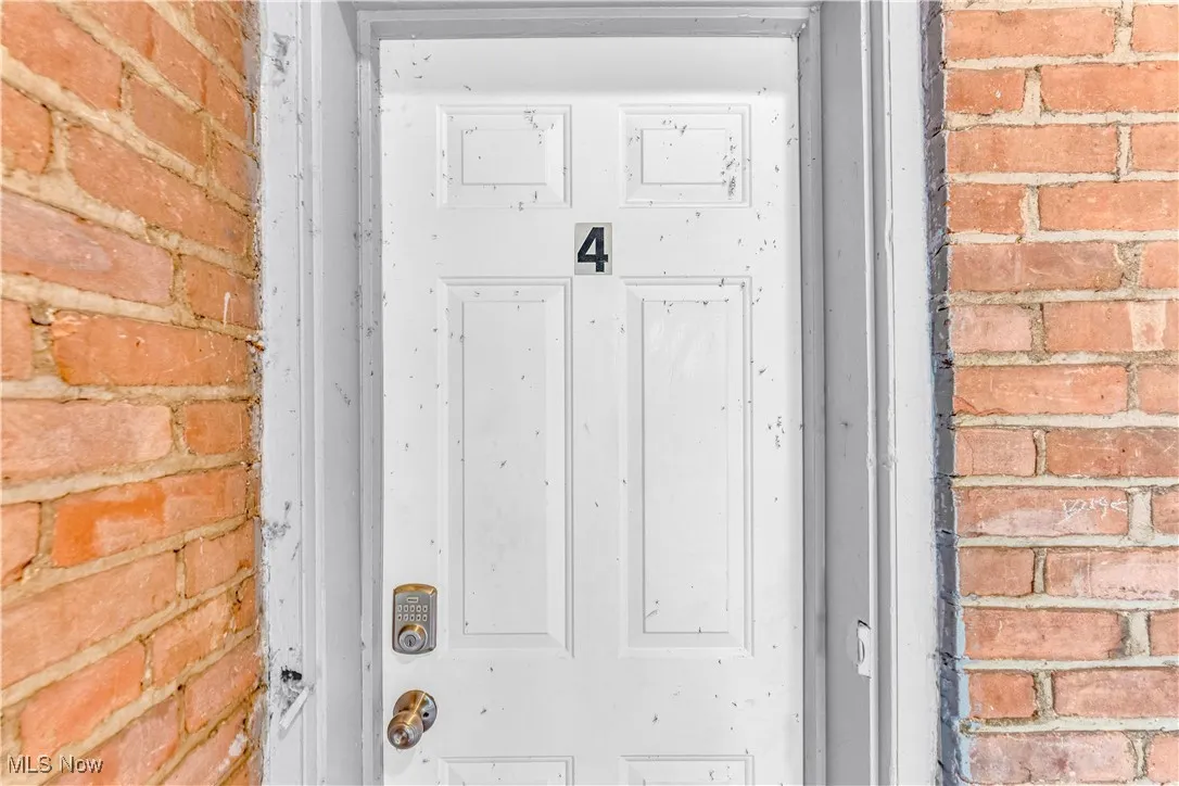 Entrance to property with brick siding