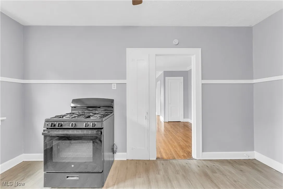 Kitchen with black range with gas cooktop and wood finished floors