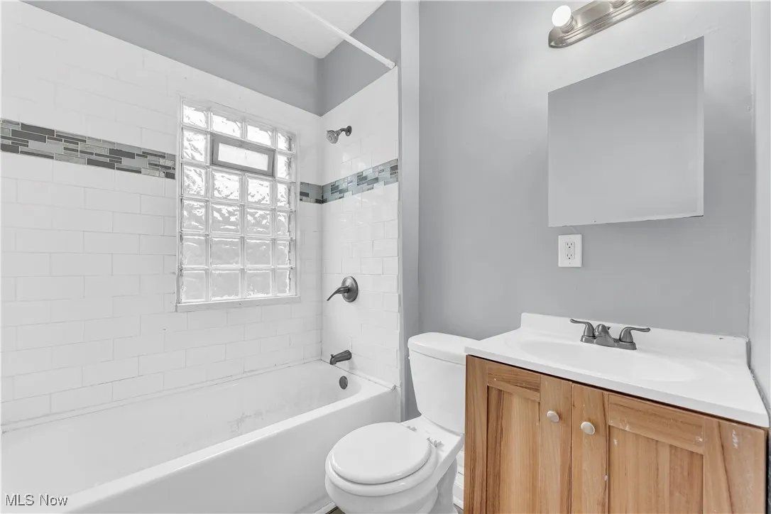 Bathroom with vanity and tub / shower combination