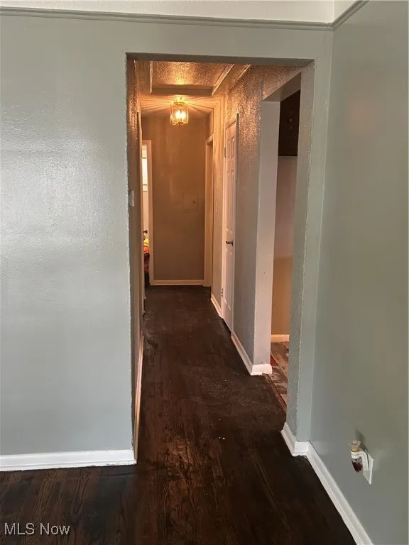 Corridor featuring wood finished floors and baseboards