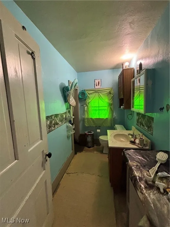 Bathroom with vanity and a textured ceiling