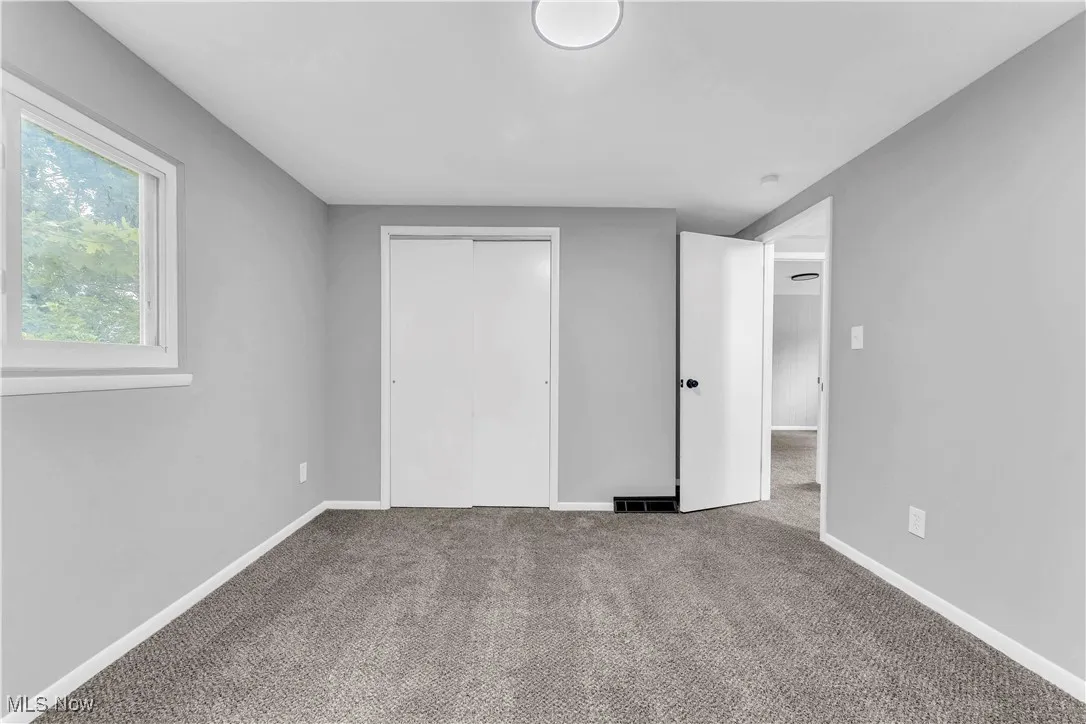 Unfurnished bedroom with carpet floors and a closet