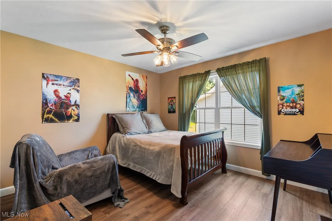 Bedroom featuring wood finished floors and a ceiling fan