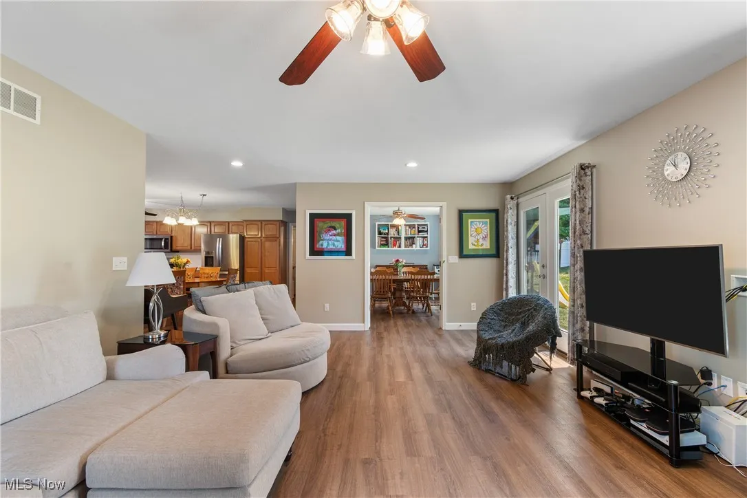 Living room with a ceiling fan, wood finished floors, recessed lighting, and a​​‌​​​​‌​​‌‌​‌‌​​​‌‌​‌​‌​‌​​​‌​​ chandelier
