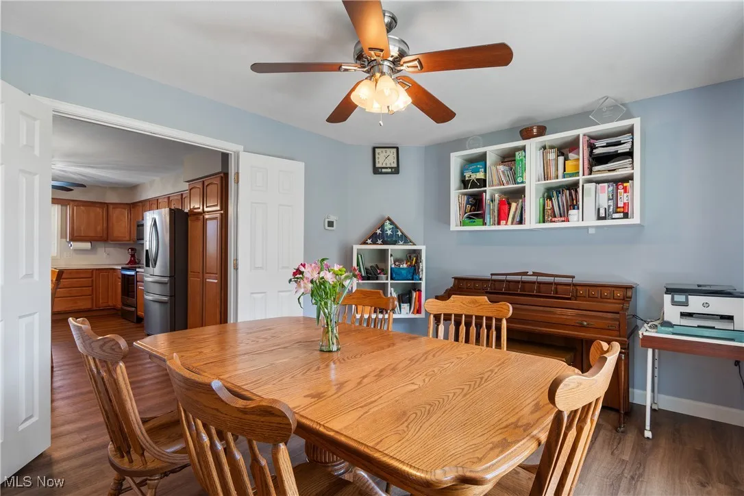Dining room featuring dark wood finished floors and a ceiling fan