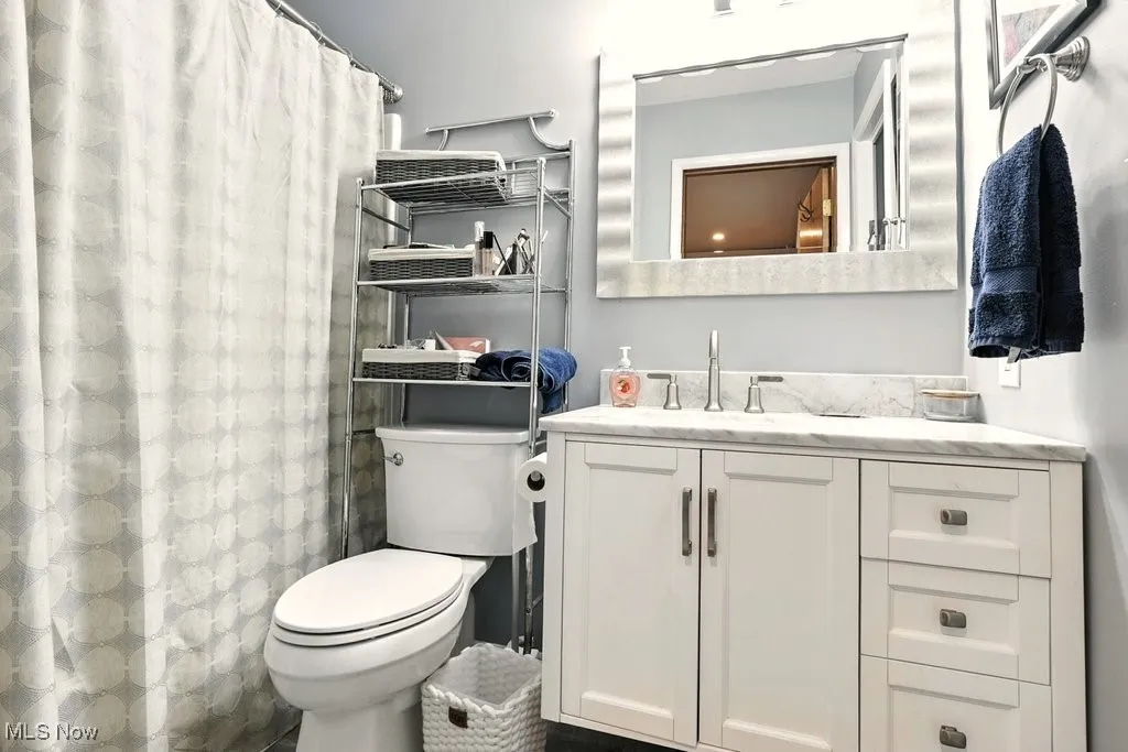 Bathroom with vanity and a shower with shower curtain
