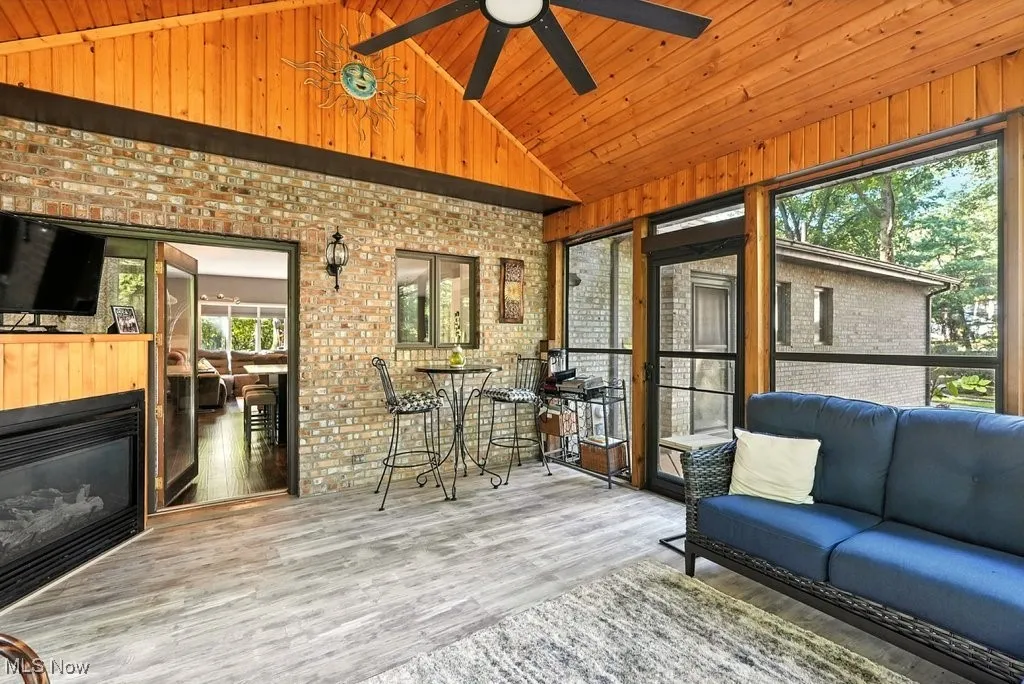 Sunroom featuring vaulted ceiling