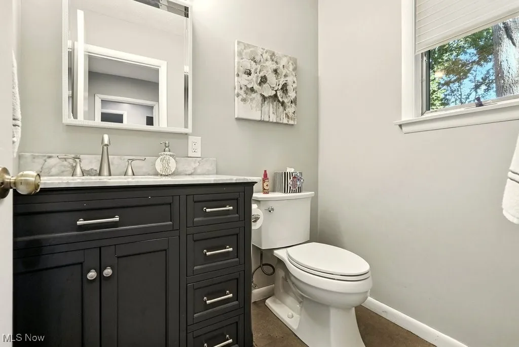 Half bathroom featuring toilet and vanity