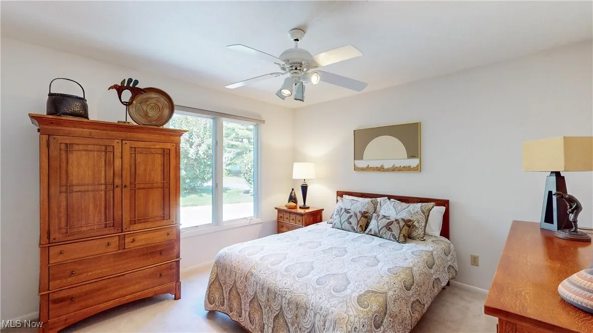Bedroom featuring light colored carpet and ceiling fan