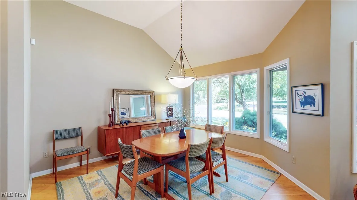 Dining space featuring lofted ceiling and light wood-style flooring