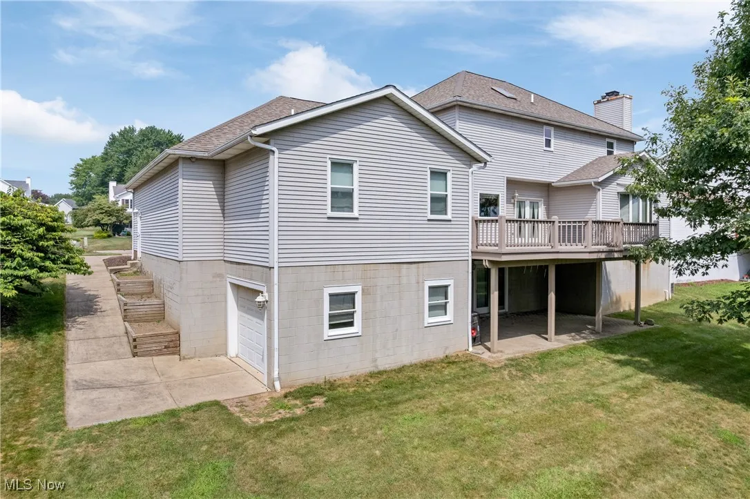 Back of house w/view of garage, deck and walk out basement