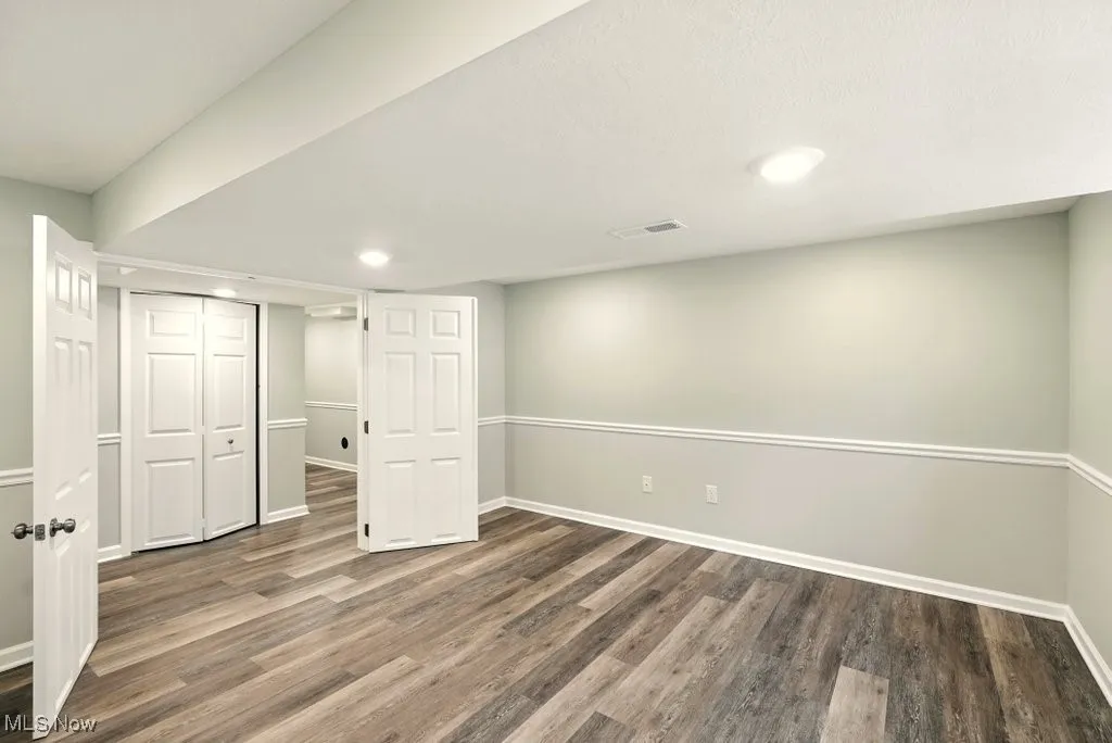 Finished basement featuring wood finished floors and recessed lighting