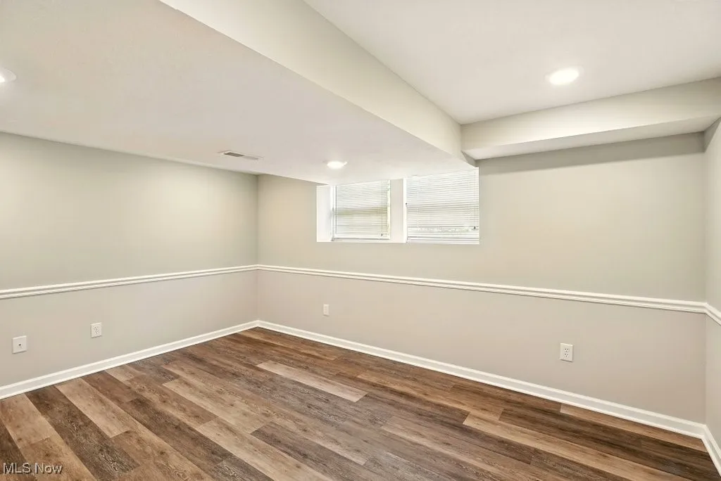 Below grade area featuring wood finished floors and recessed lighting
