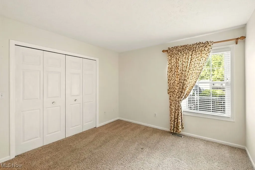 Unfurnished bedroom with carpet floors and a closet