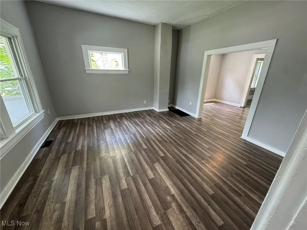 Unfurnished living room with dark wood-type LVP flooring