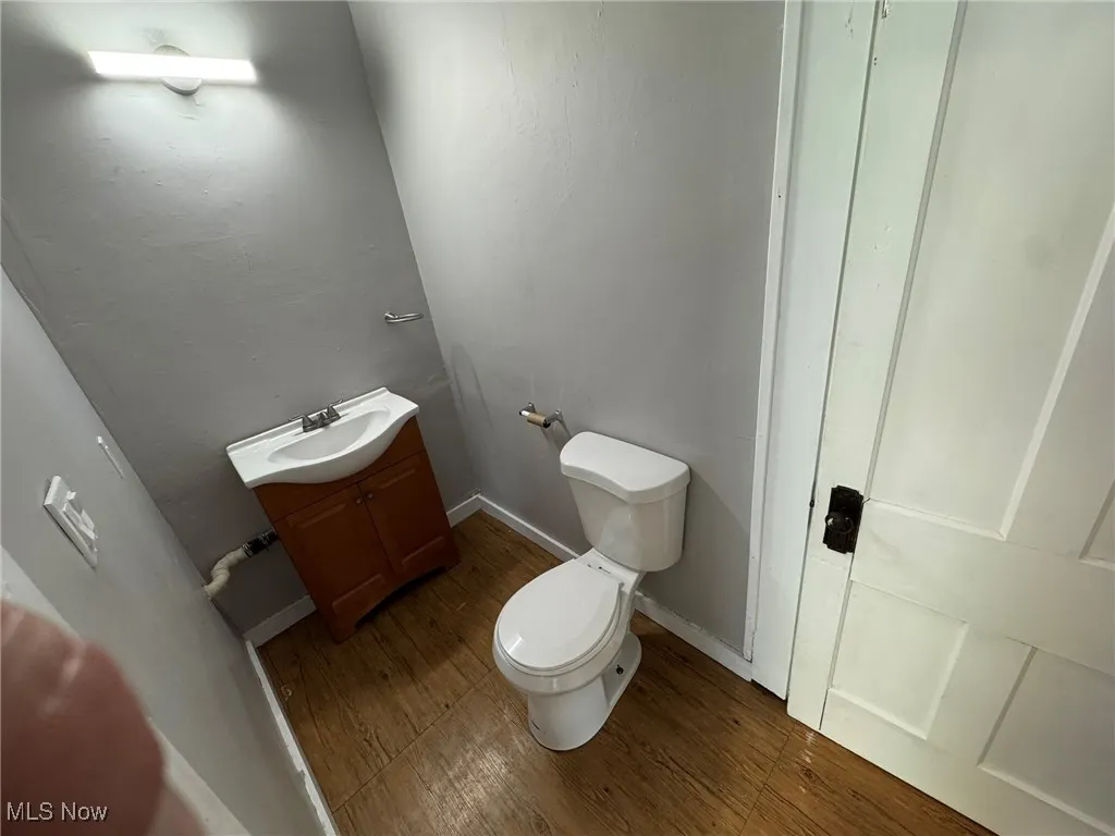 Half bathroom on first floor with vanity and wood LVP floors