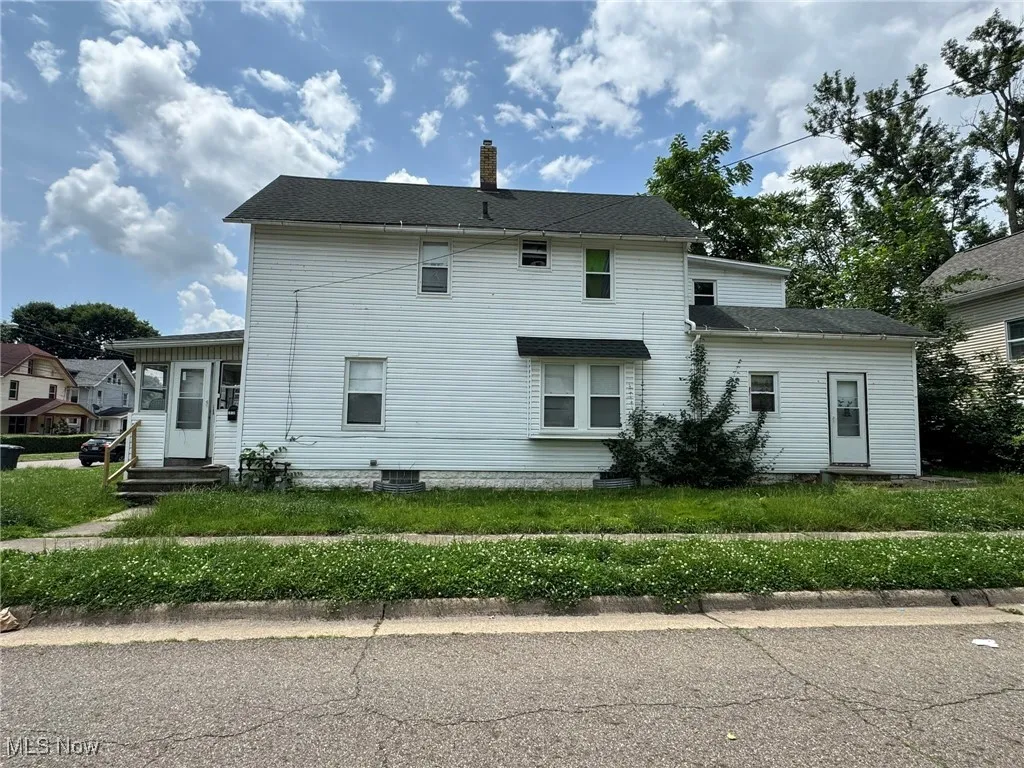 Back of house with a chimney