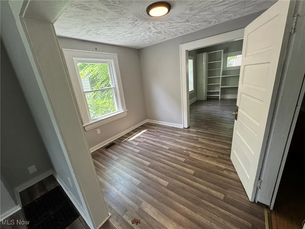 Office area between living and dining rooms with a convenient half-bath doorway on right