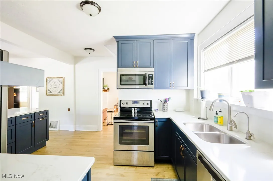 Kitchen with stainless steel appliances and light wood-type flooring