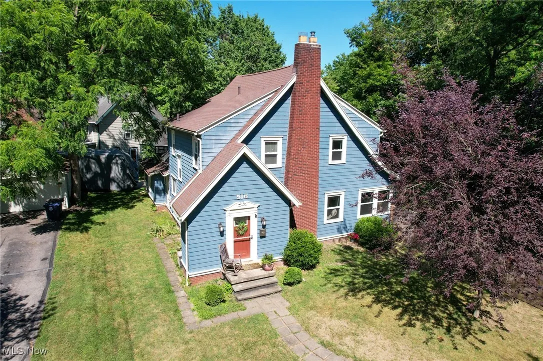 View of front of property featuring a chimney and a front yard