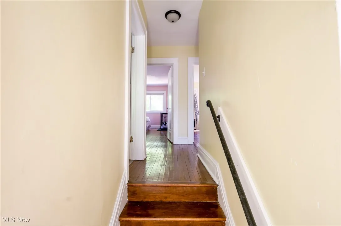 Stairs with baseboards and wood-type flooring