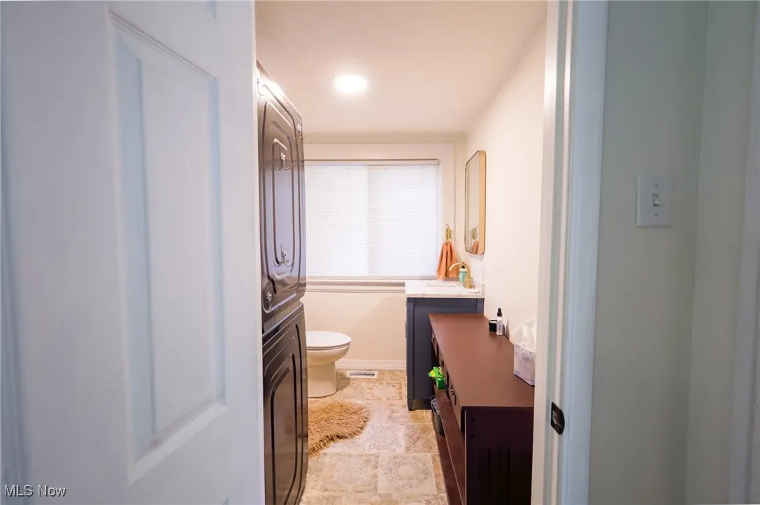 Bathroom with vanity and stone finish floors