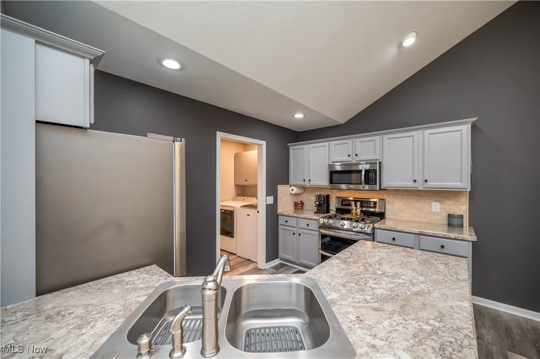 Updated Kitchen with Laundry Room beyond. Note the lovely, new countertops!