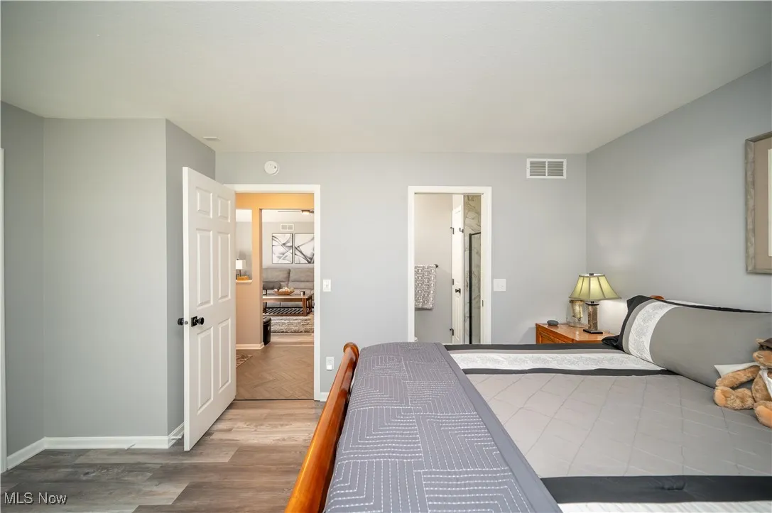 Secondary bedroom, looking into both foyer and bathroom.