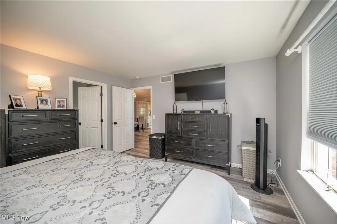 Bedroom with wood finished floors and baseboards
