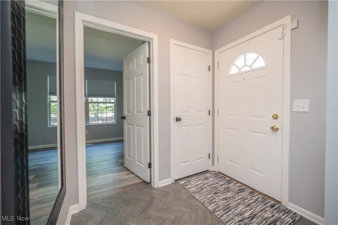 Entrance foyer, featuring parquet floor. Looking into secondary bedroom.
