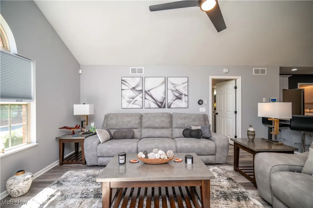 Living area with Kitchen breakfast bar to right.