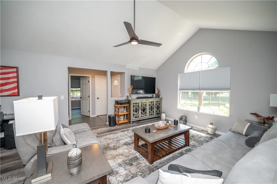 Greatroom (consisting of formal living & dining areas) features cathedral ceiling and palladium window. This photo shows foyer and, beyond that, door to secondary bedroom.